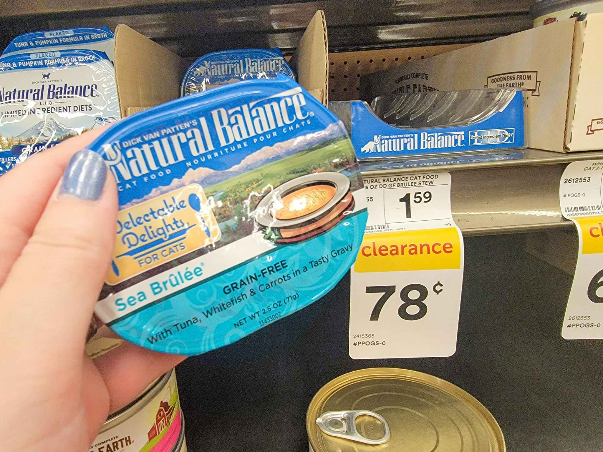 hand holding a container of natural balance cat food