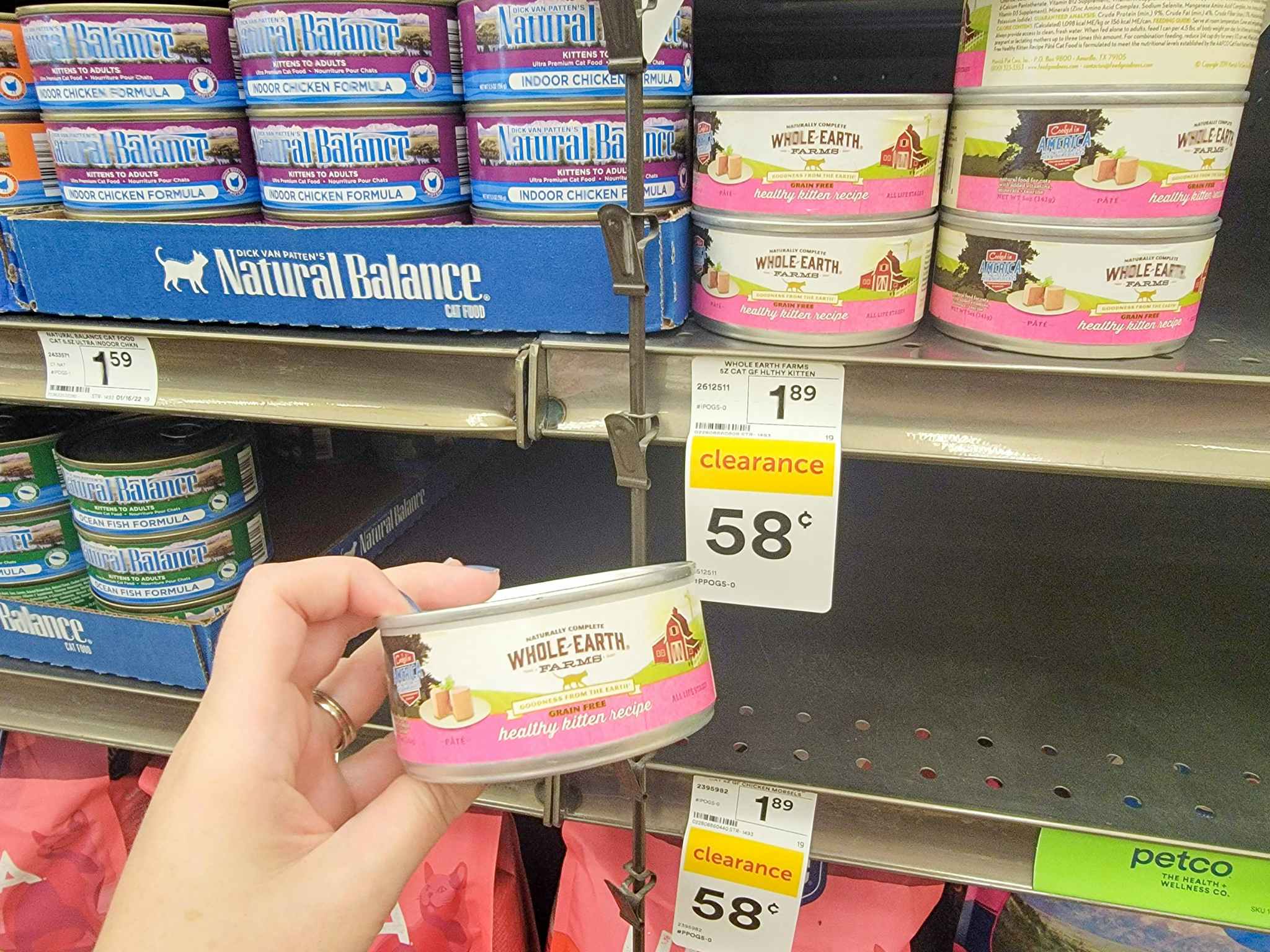 hand holding a can of whole earth healthy kitten cat food