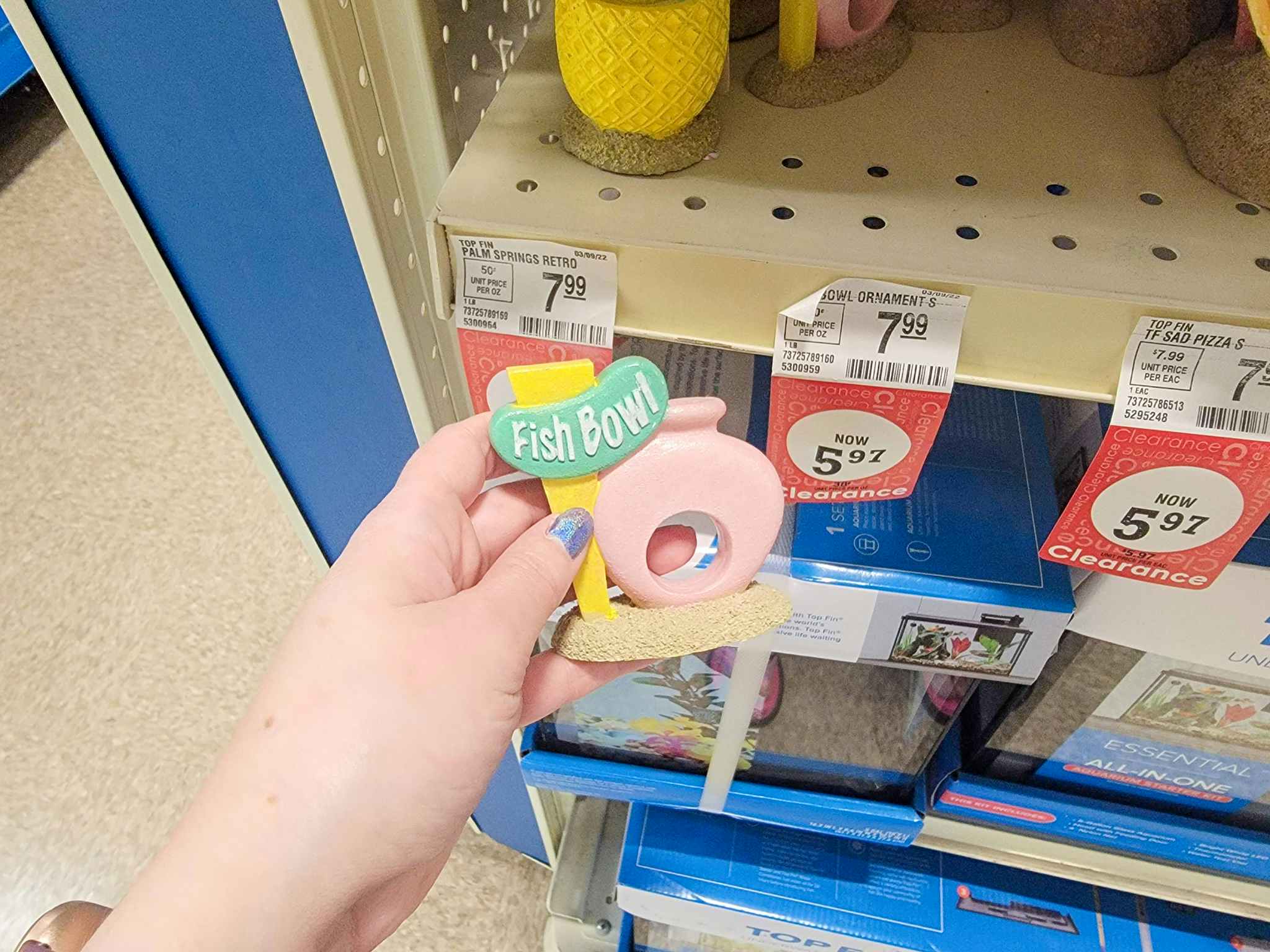 hand holding a fish bowl aquarium decoration