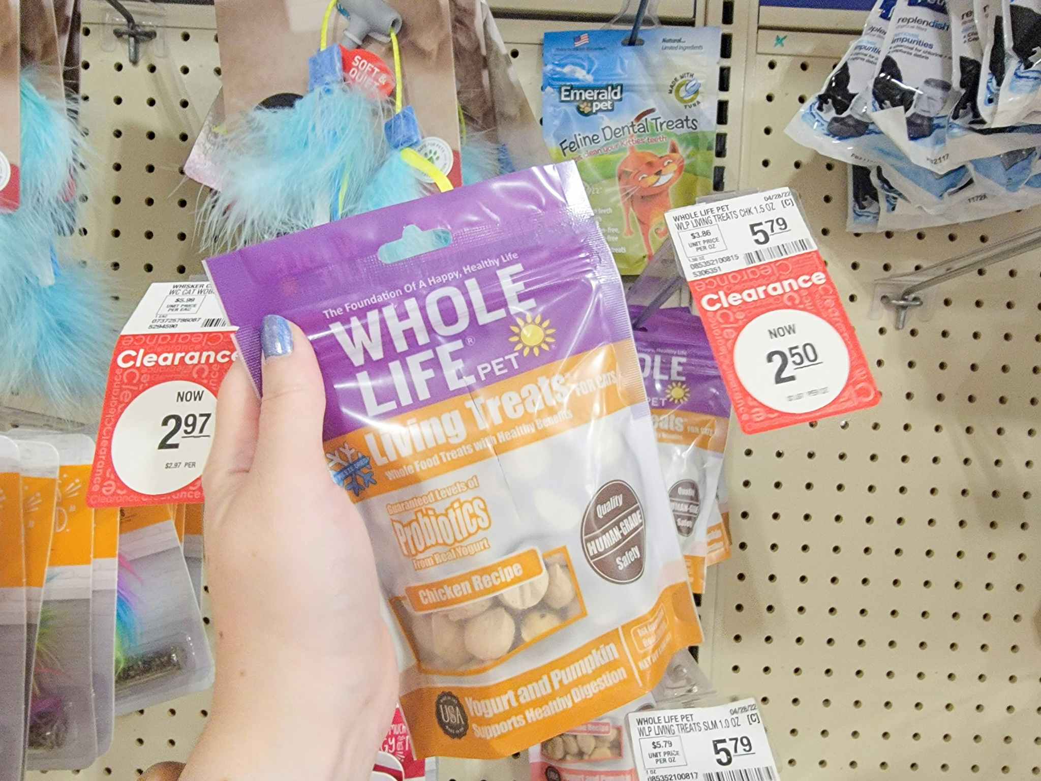 hand holding up a bag of cat treats by the clearance tag