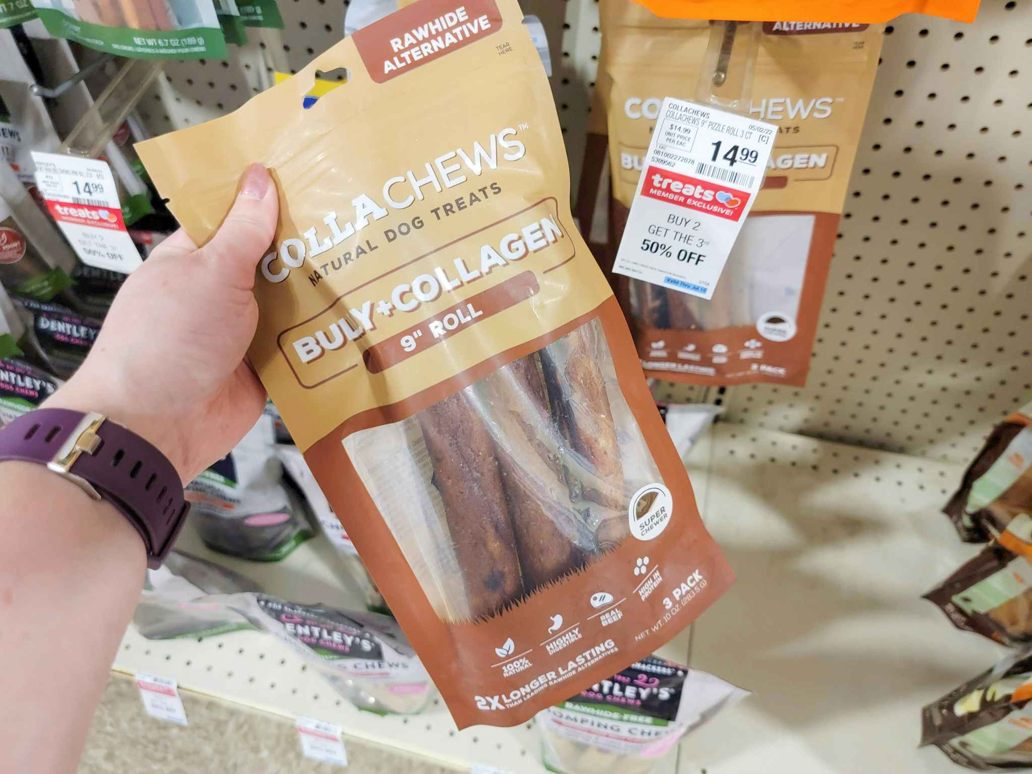 hand holding a bag of dog chews