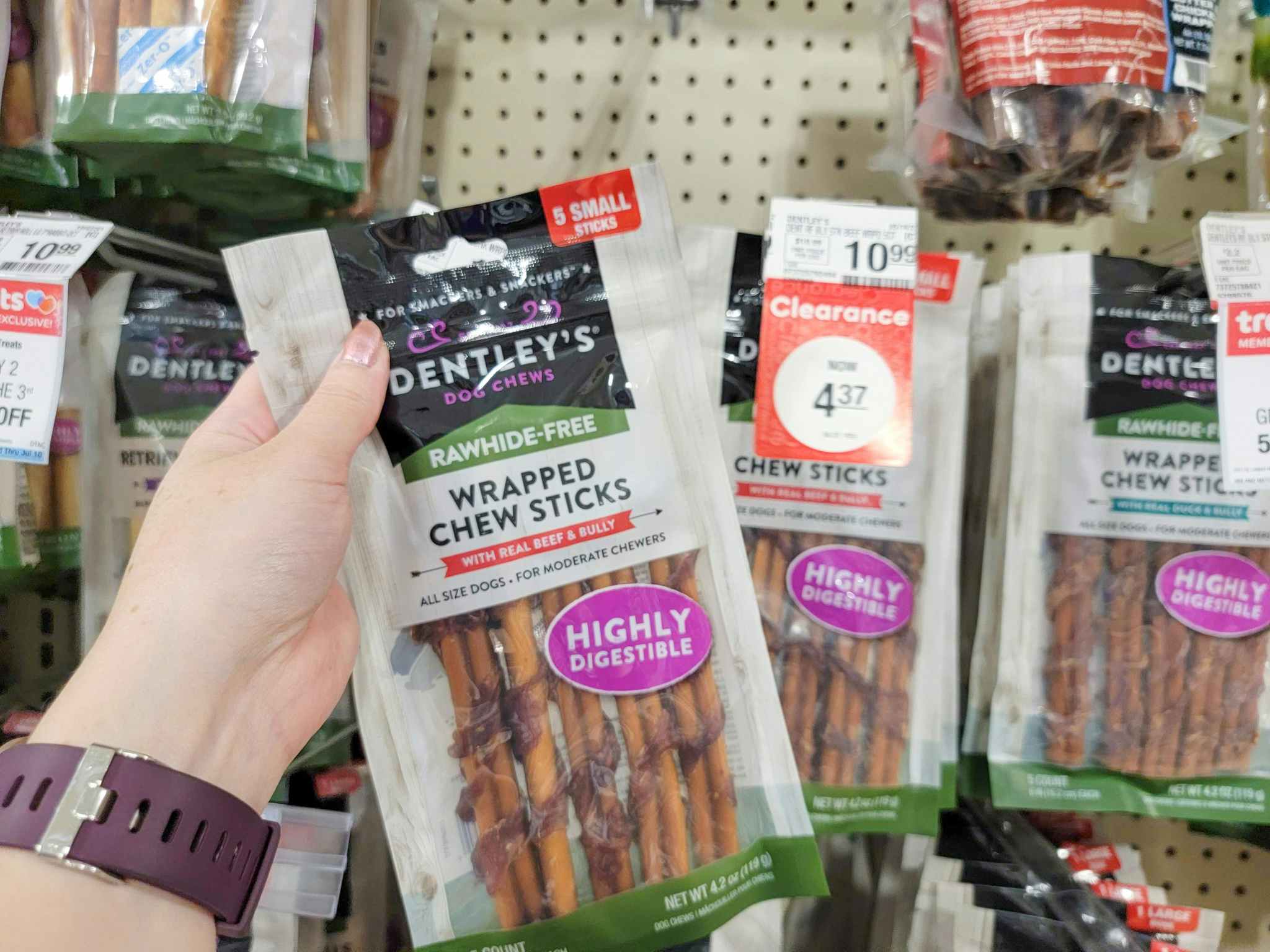 hand holding a bag of Dentley's dog chews