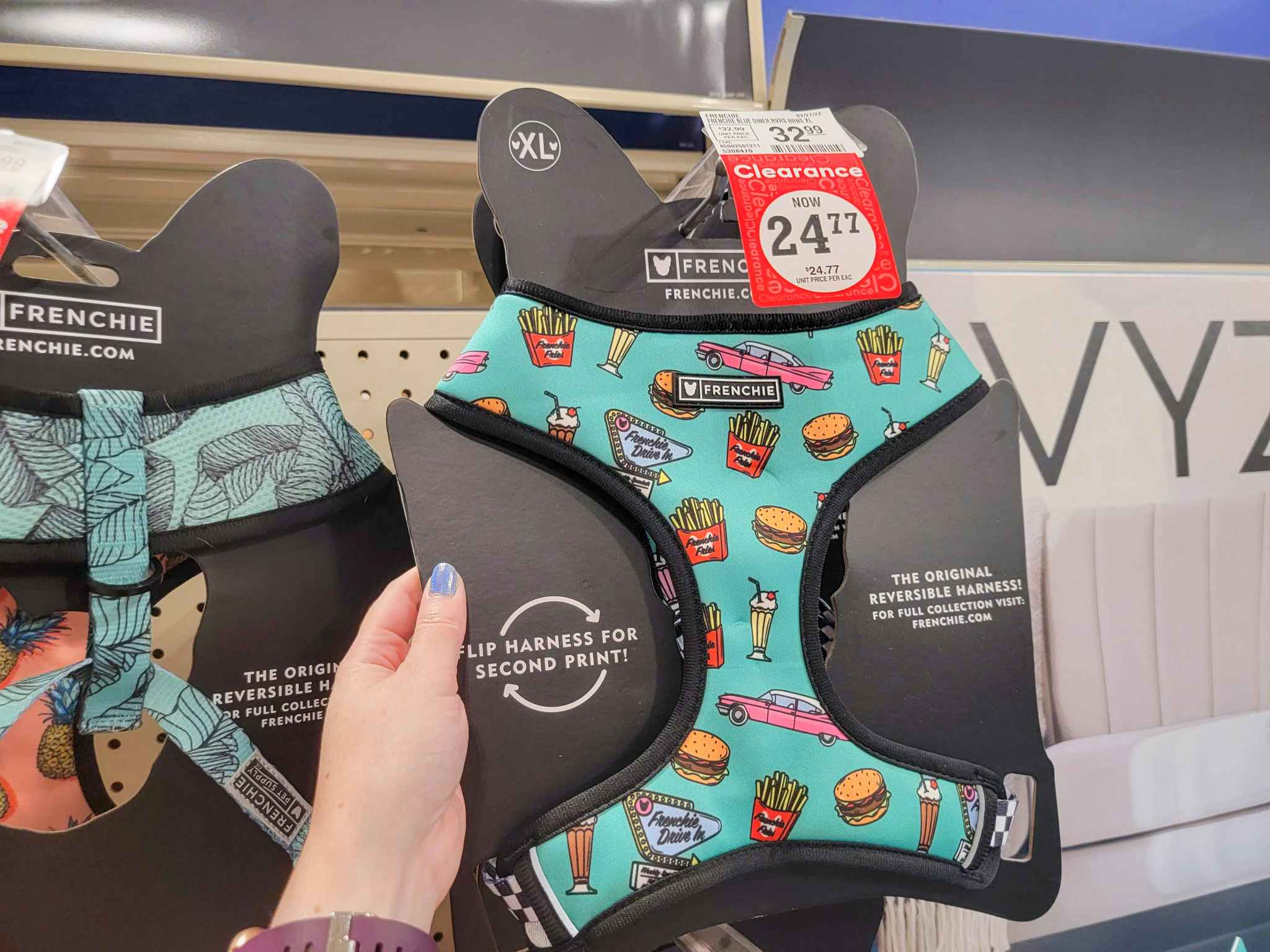 hand holding a diner-themed dog harness