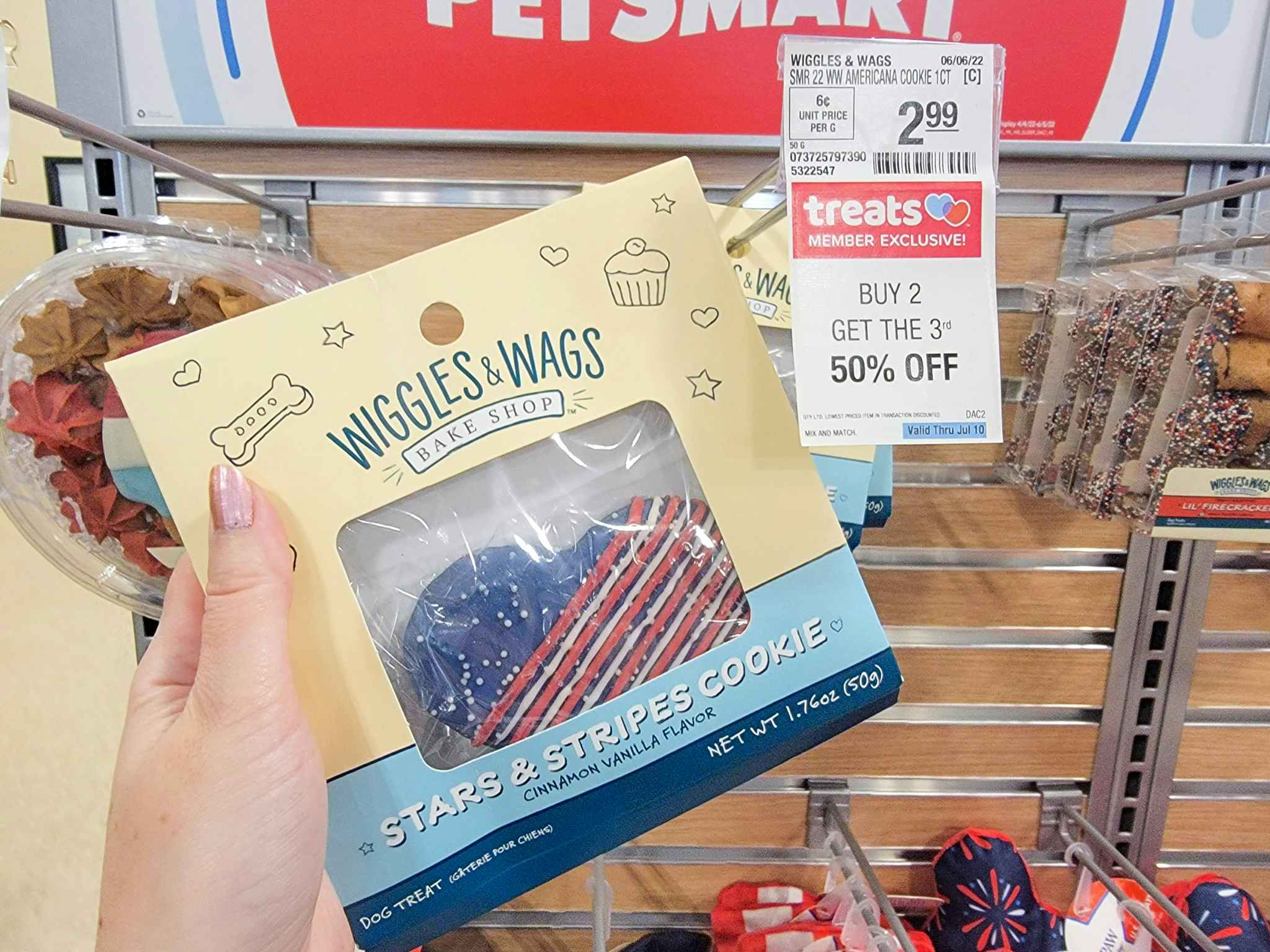 hand holding Fourth of July dog cookie at Petsmart