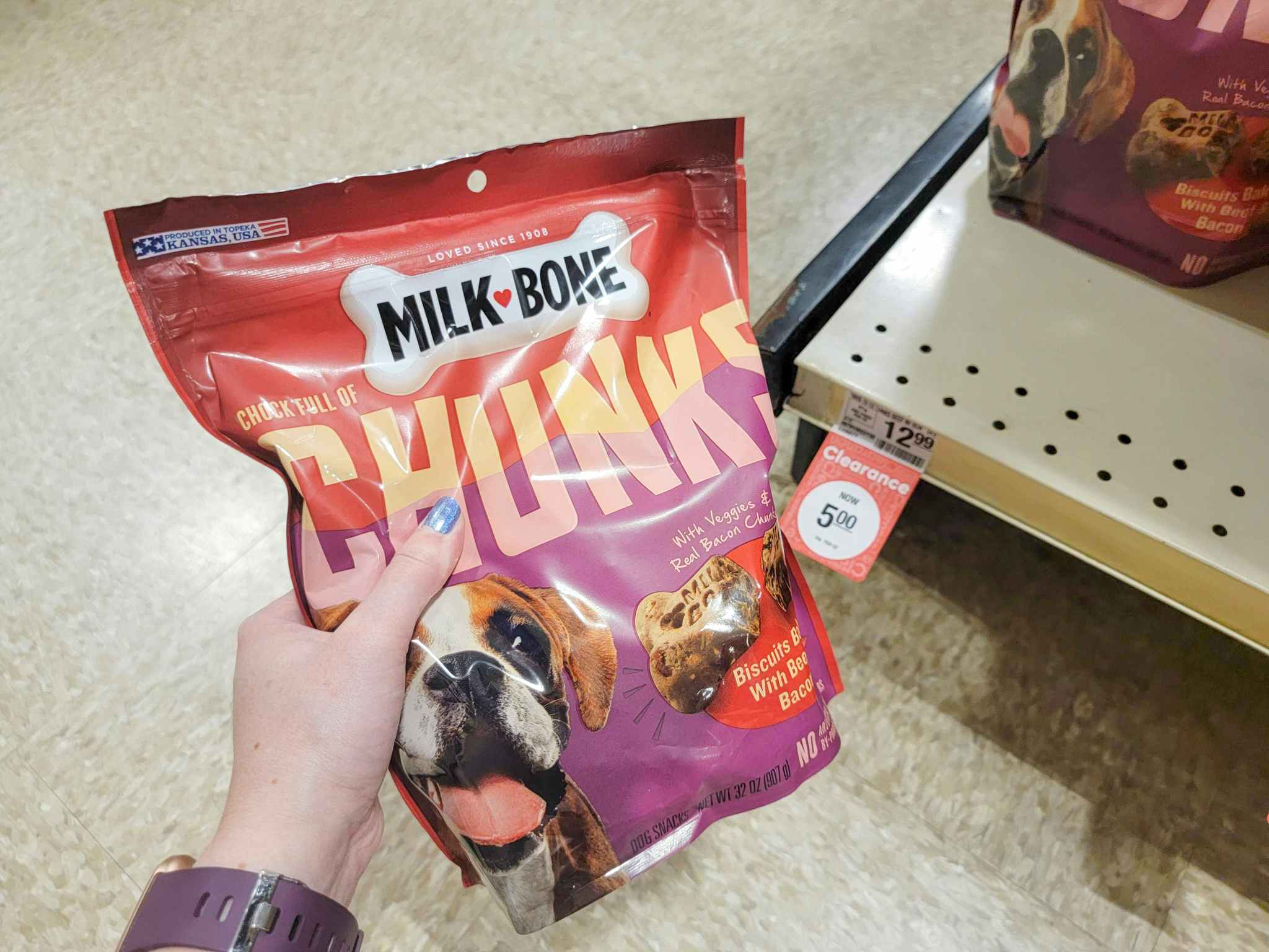 hand holding milk bone treats