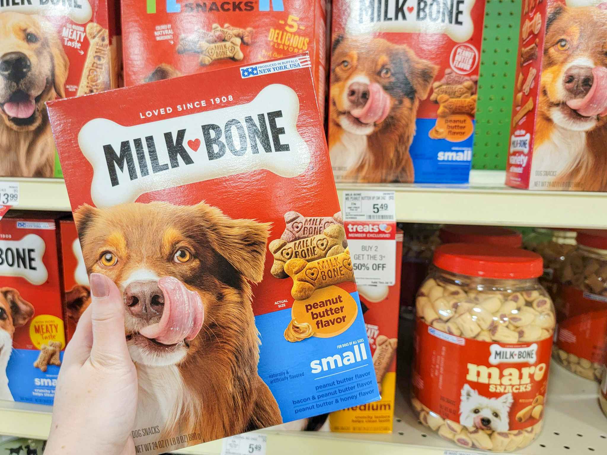 hand holding a box of milk bone dog treats