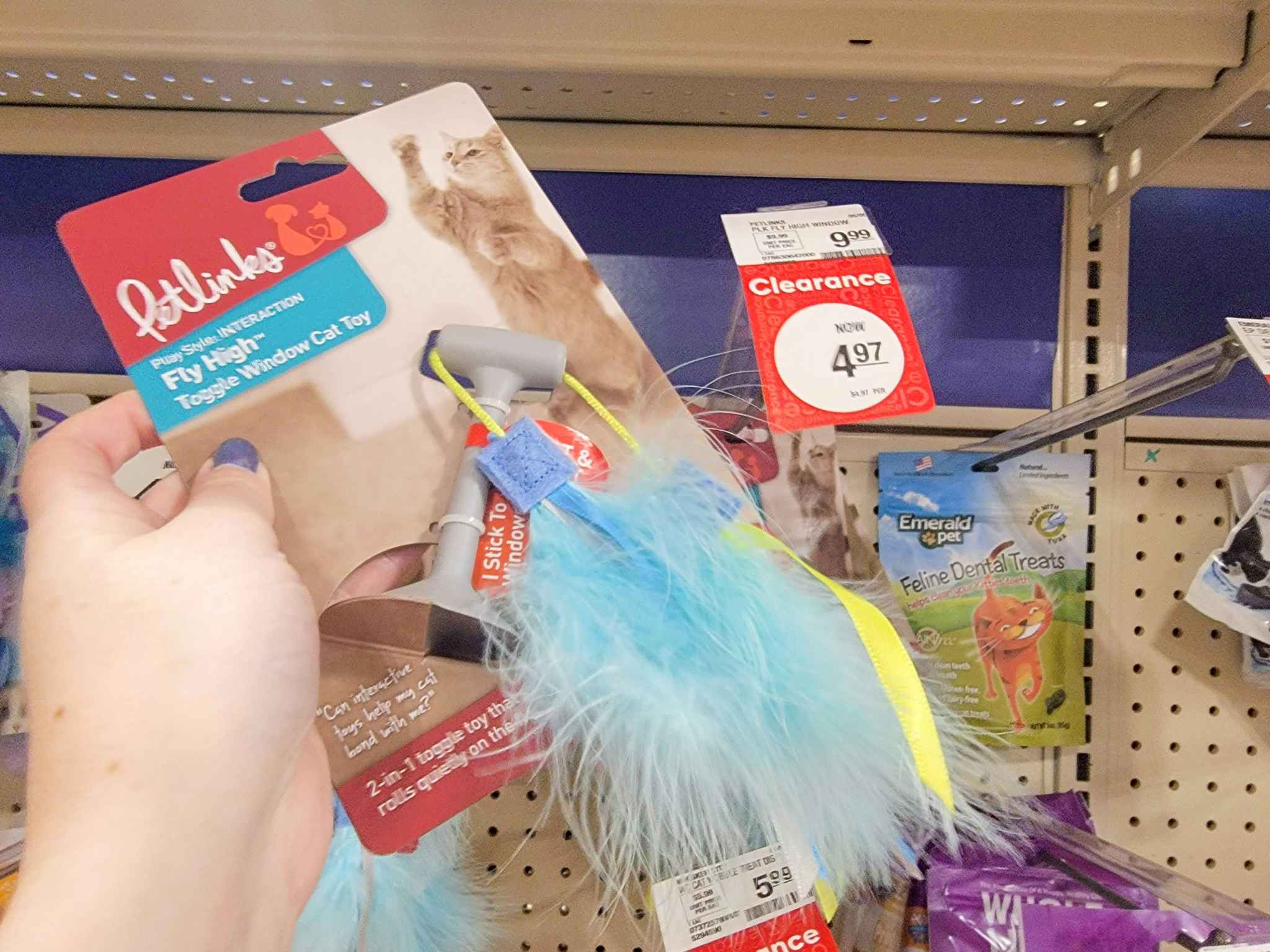 hand holding a cat toy by the clearance tag