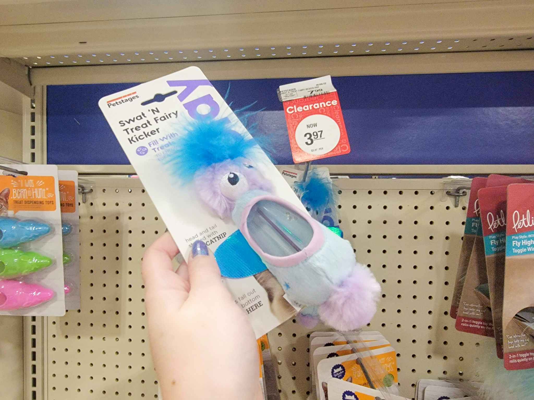 hand holding a catnip toy by the clearance tag