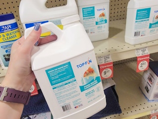 hand holding a bottle of pond water conditioner