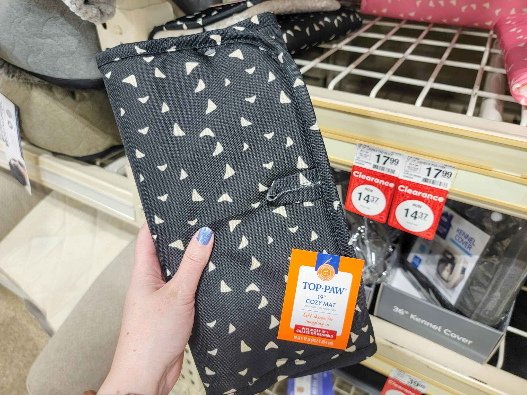 hand holding a black cozy mat for dogs