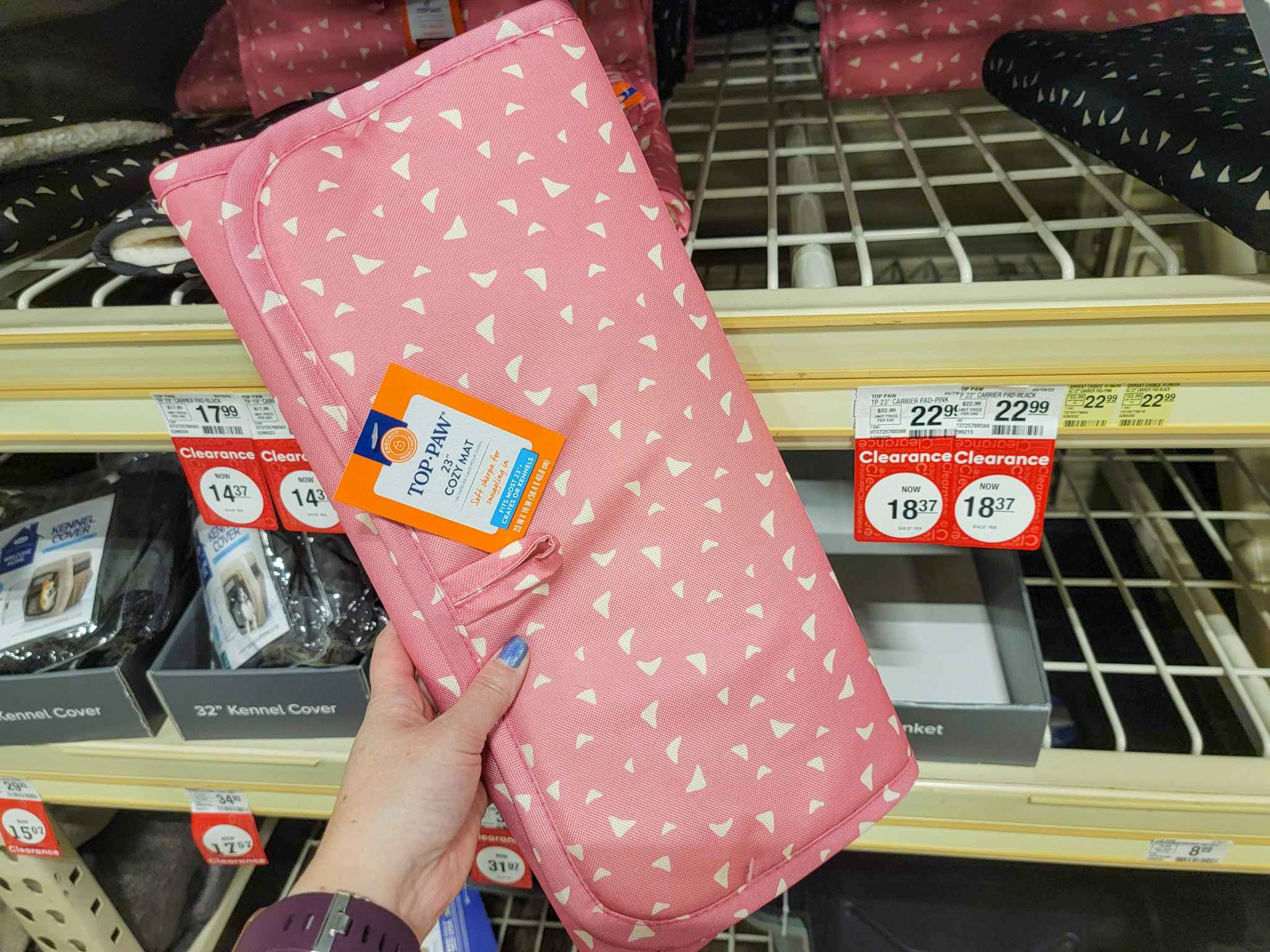 hand holding a pink cozy mat for dogs