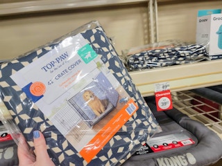 hand holding a large crate cover