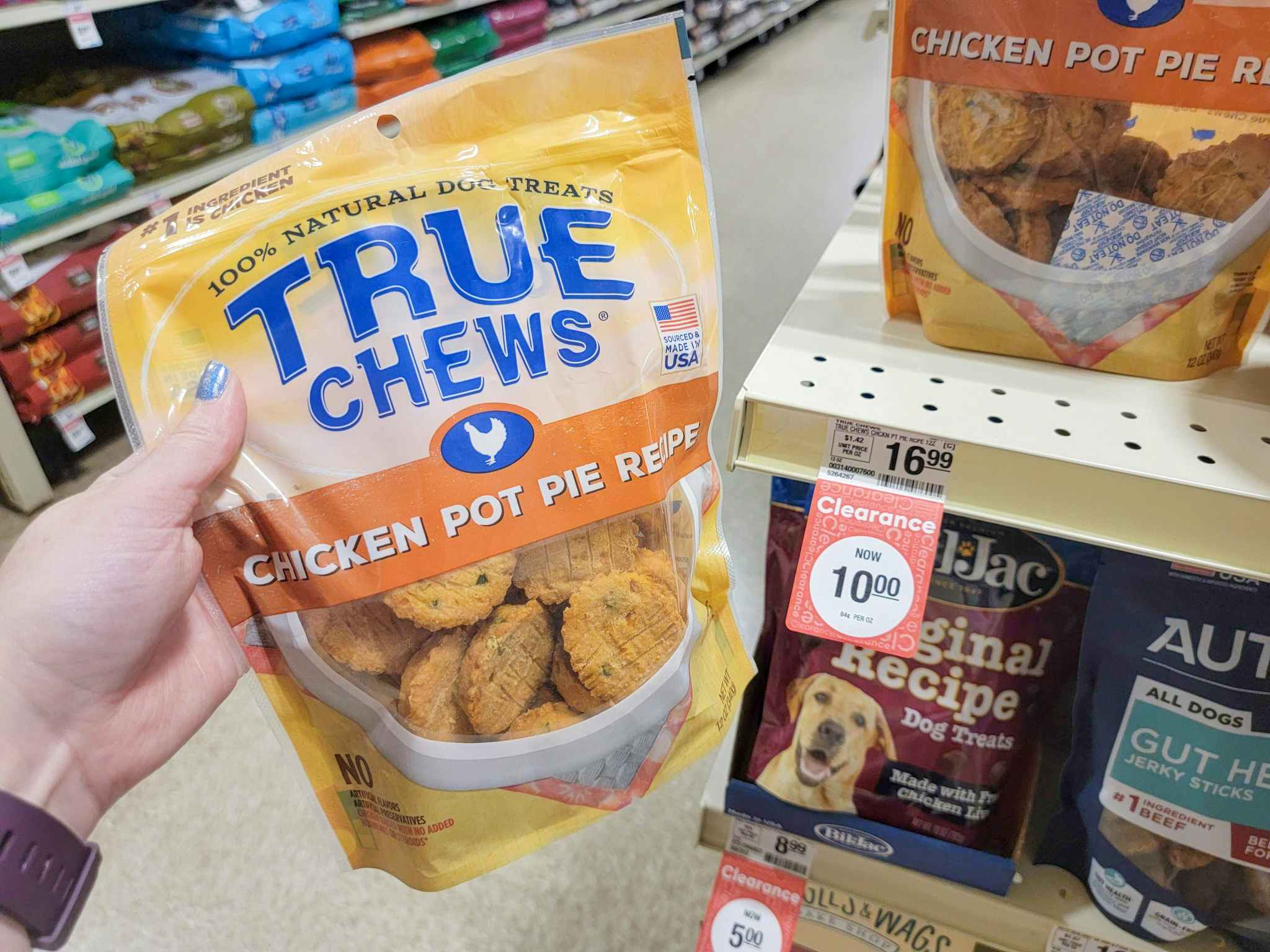 hand holding a bag of true chews chicken pot pie dog treats
