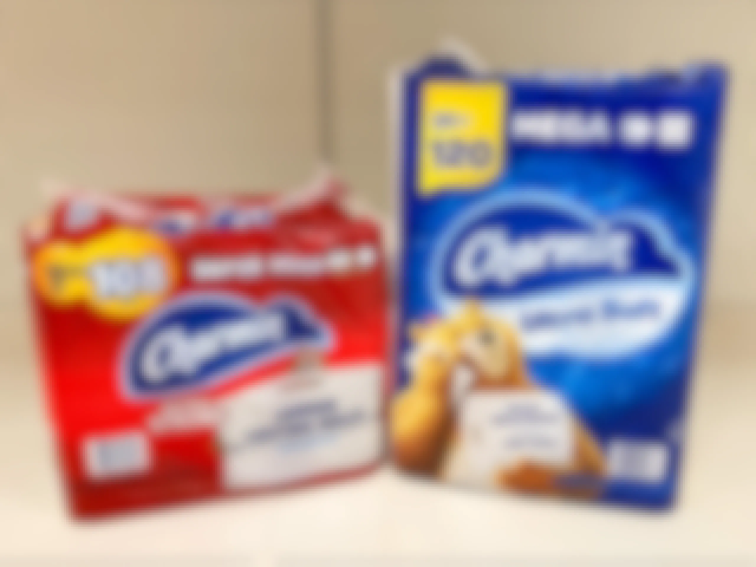 Two packages of Charmin toilet paper on store shelf