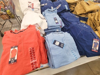 four colors of gap henley tees on a table, burnt orange, white, light blue, and navy