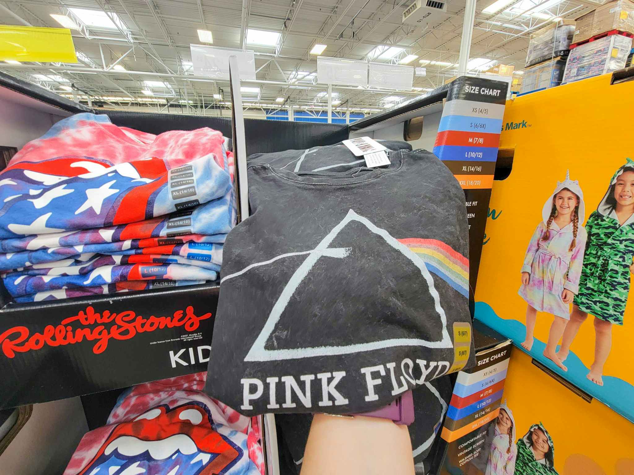 hand holding a kids' pink floyd t-shirt