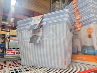 blue and white striped laundry hampers on a shelf