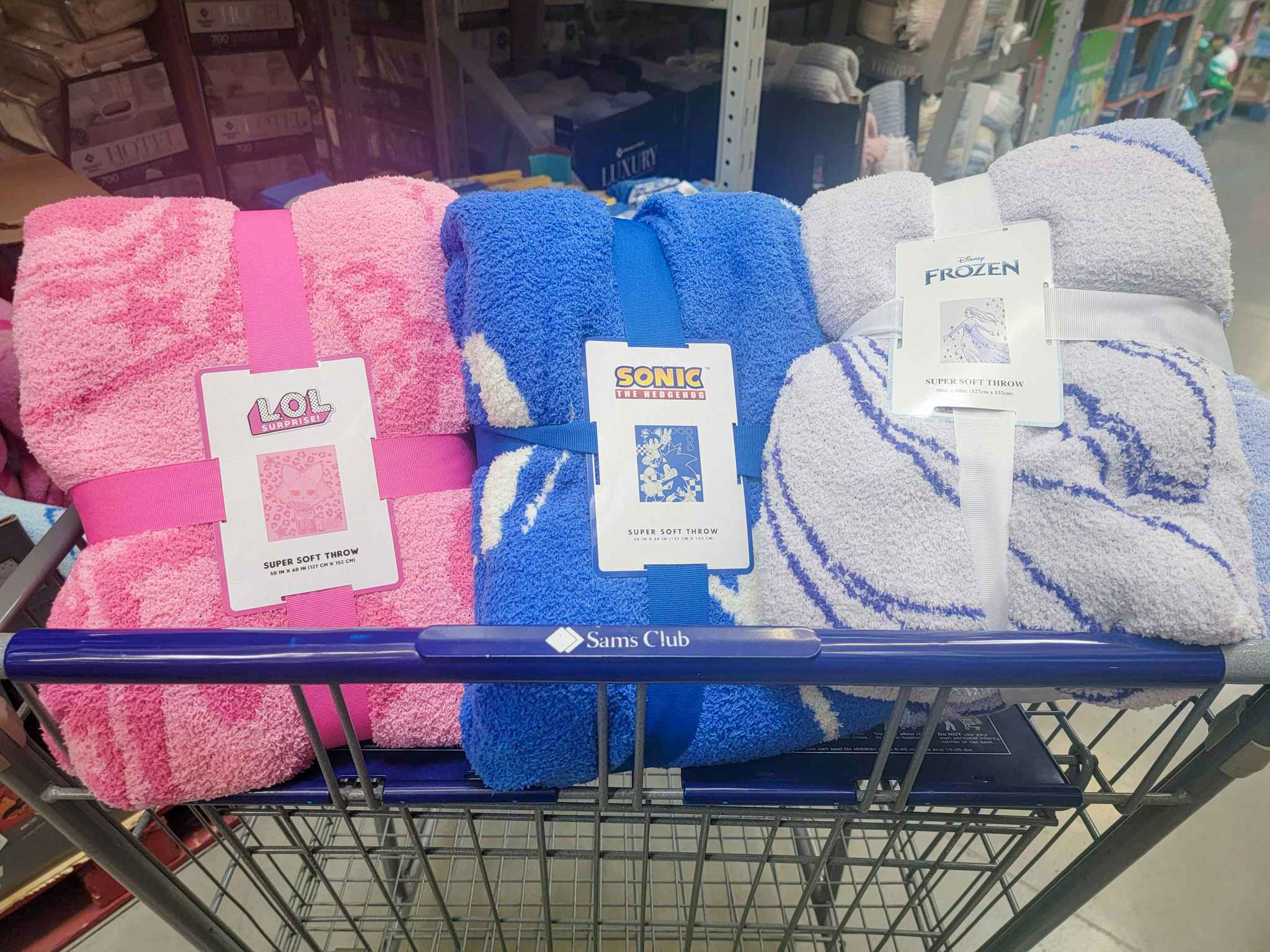 LOL surprise, sonic, and disney frozen throw blankets in a cart