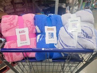 LOL surprise, sonic, and disney frozen throw blankets in a cart
