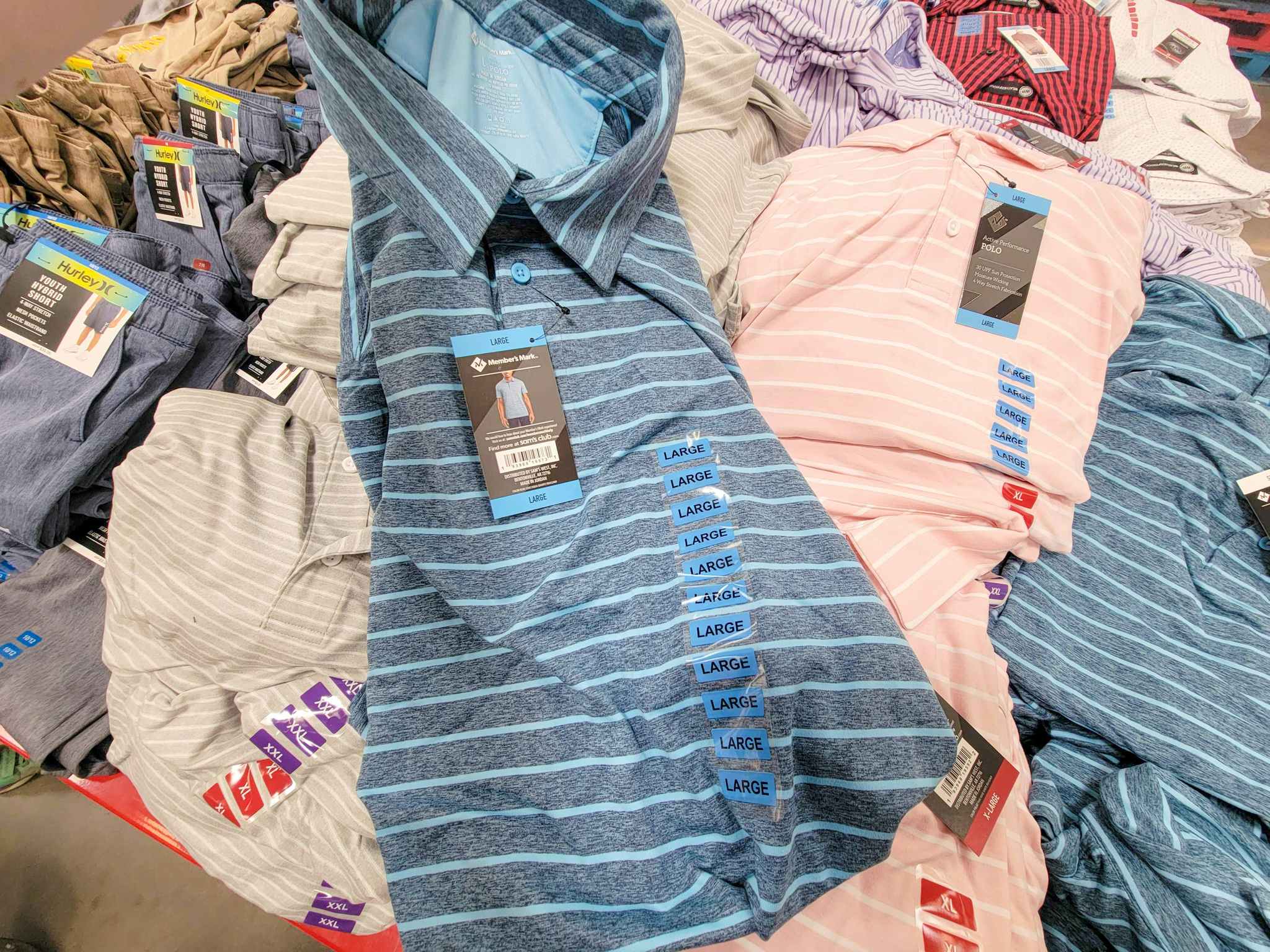 a blue striped active polo on top of other polo shirts