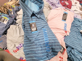 a blue striped active polo on top of other polo shirts