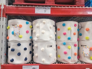 Sets of pom pom canvas storage bins on a shelf