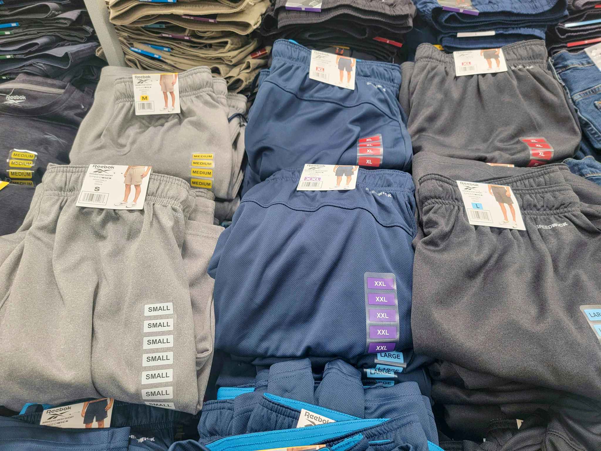 Men's Reebok shorts on a table in a variety of colors