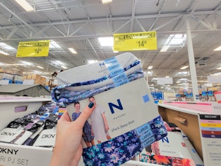 hand holding a 2-pack of blue ladies sleep shirts