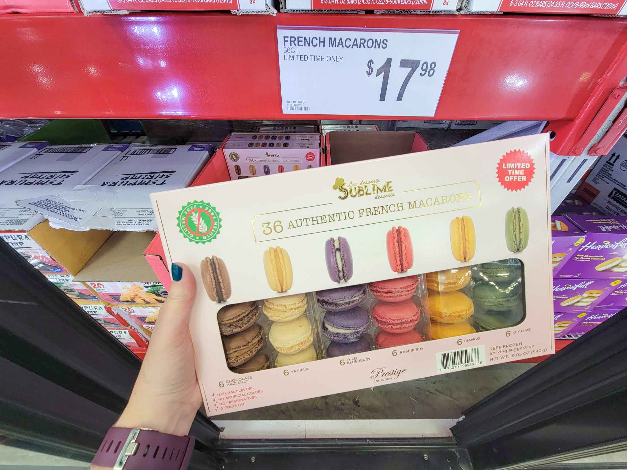 hand holding a package of macarons