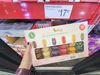 hand holding a package of macarons