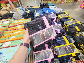 hand holding a 2-pack of womens' active tank tops