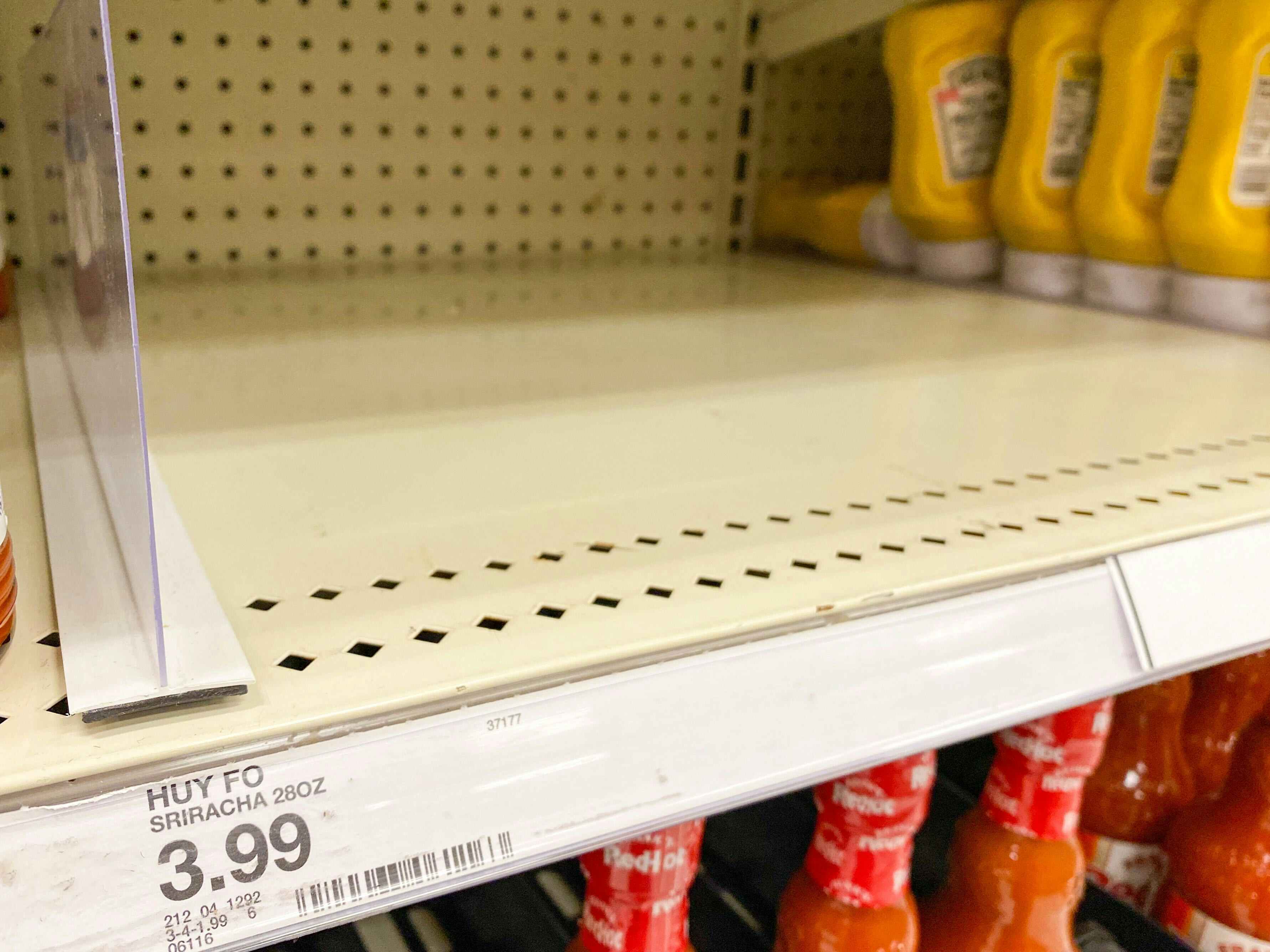 Empty spot on a shelf at Target where Sriracha hot sauce is supposed to be