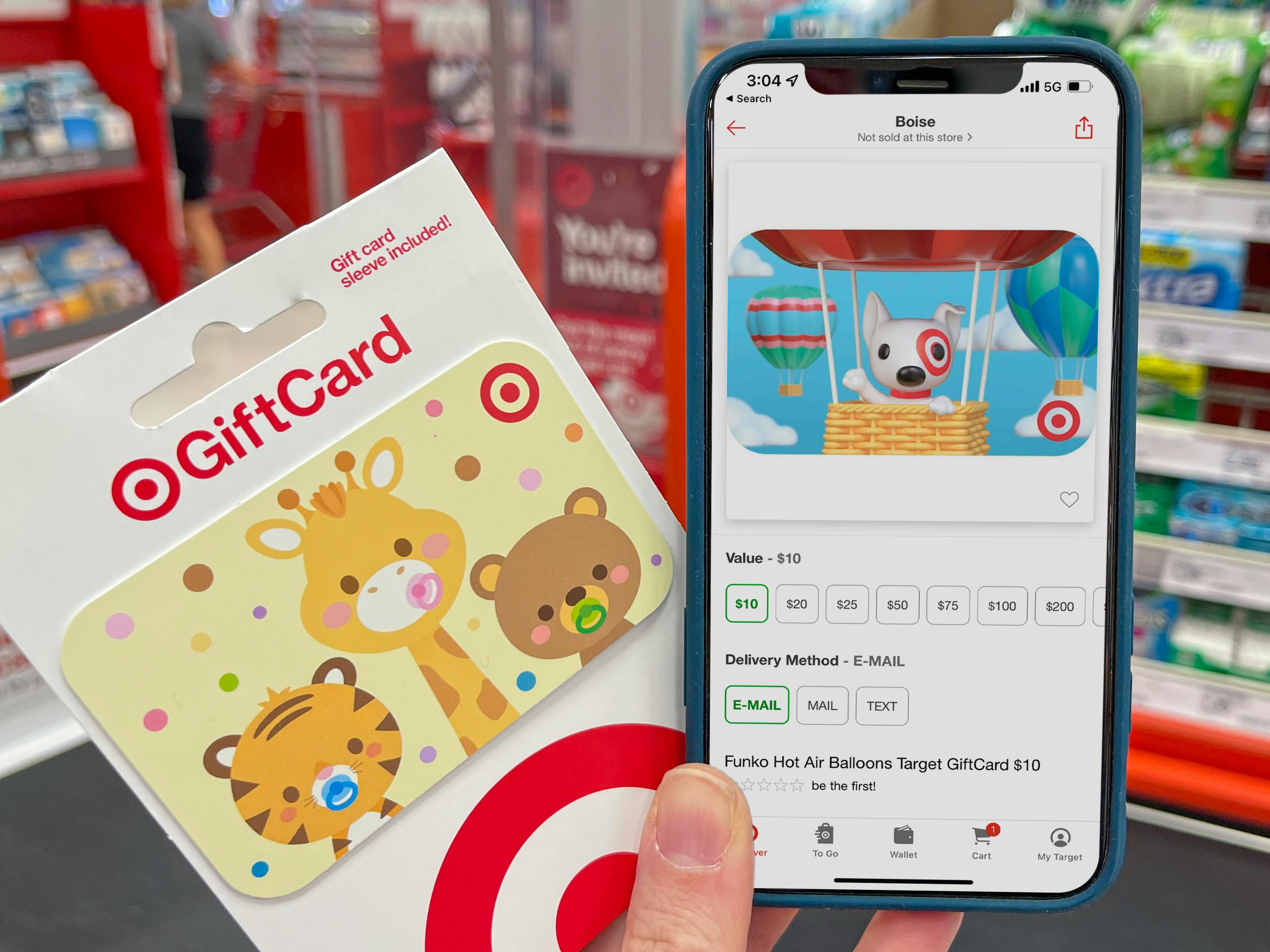 A person holding a target gift card with a cell phone displaying a digital target gift card on the target app.