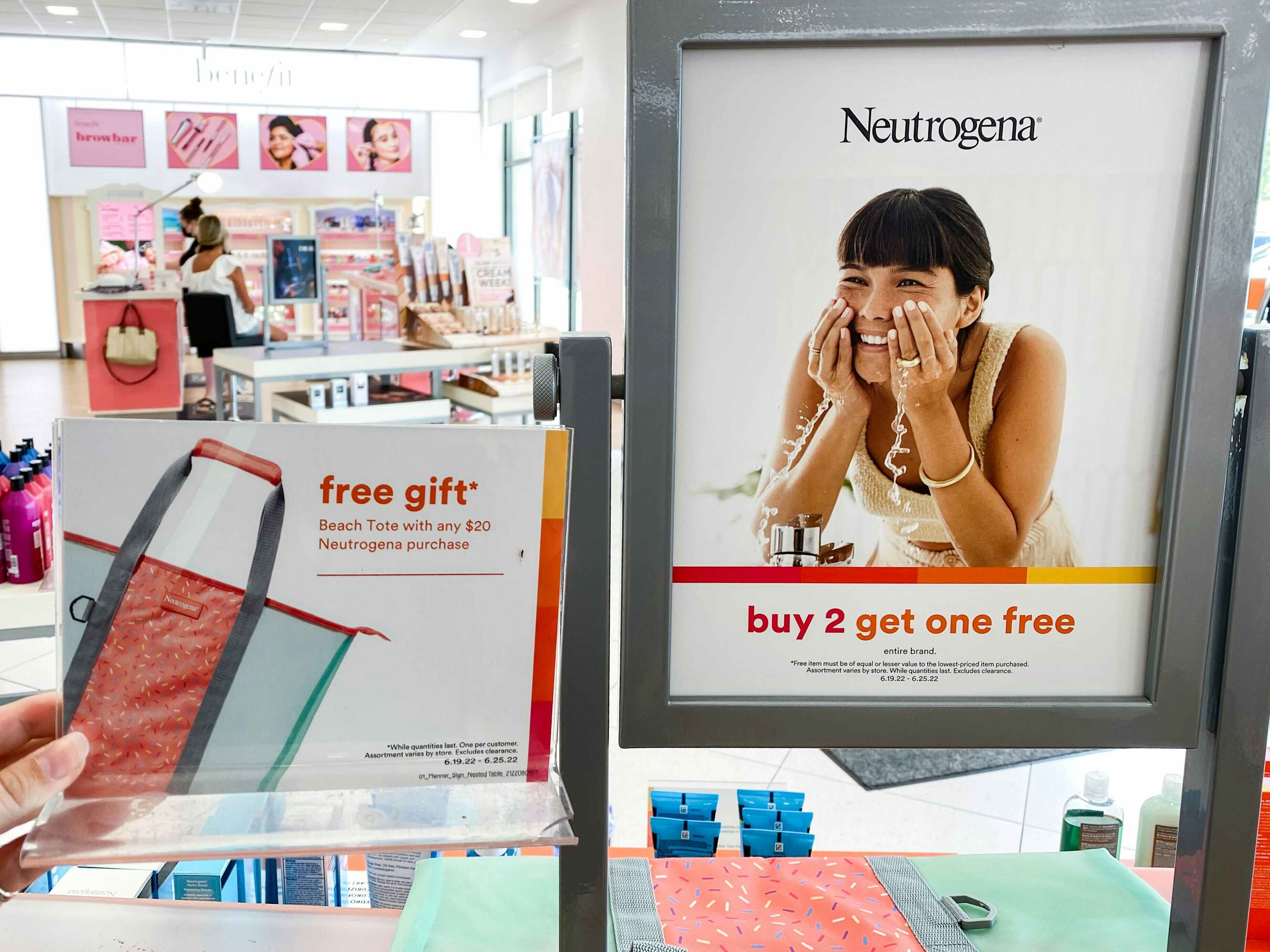 a free neutrogena tote next to a sign saying that if you send $20 or more on neutrogena then you get the free tote
