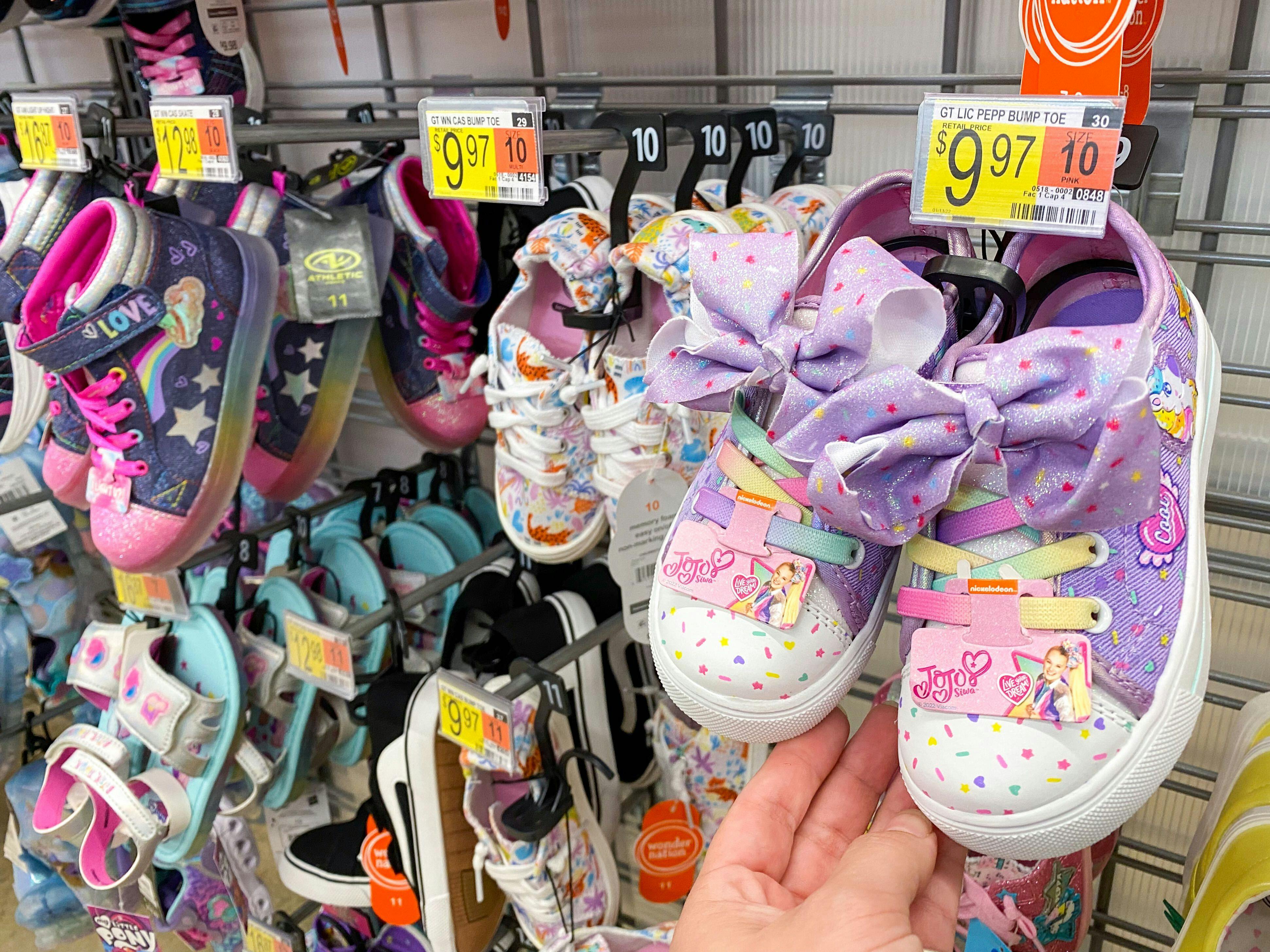 Pairs of kids shoes with sales tags showing $9.97 at Walmart