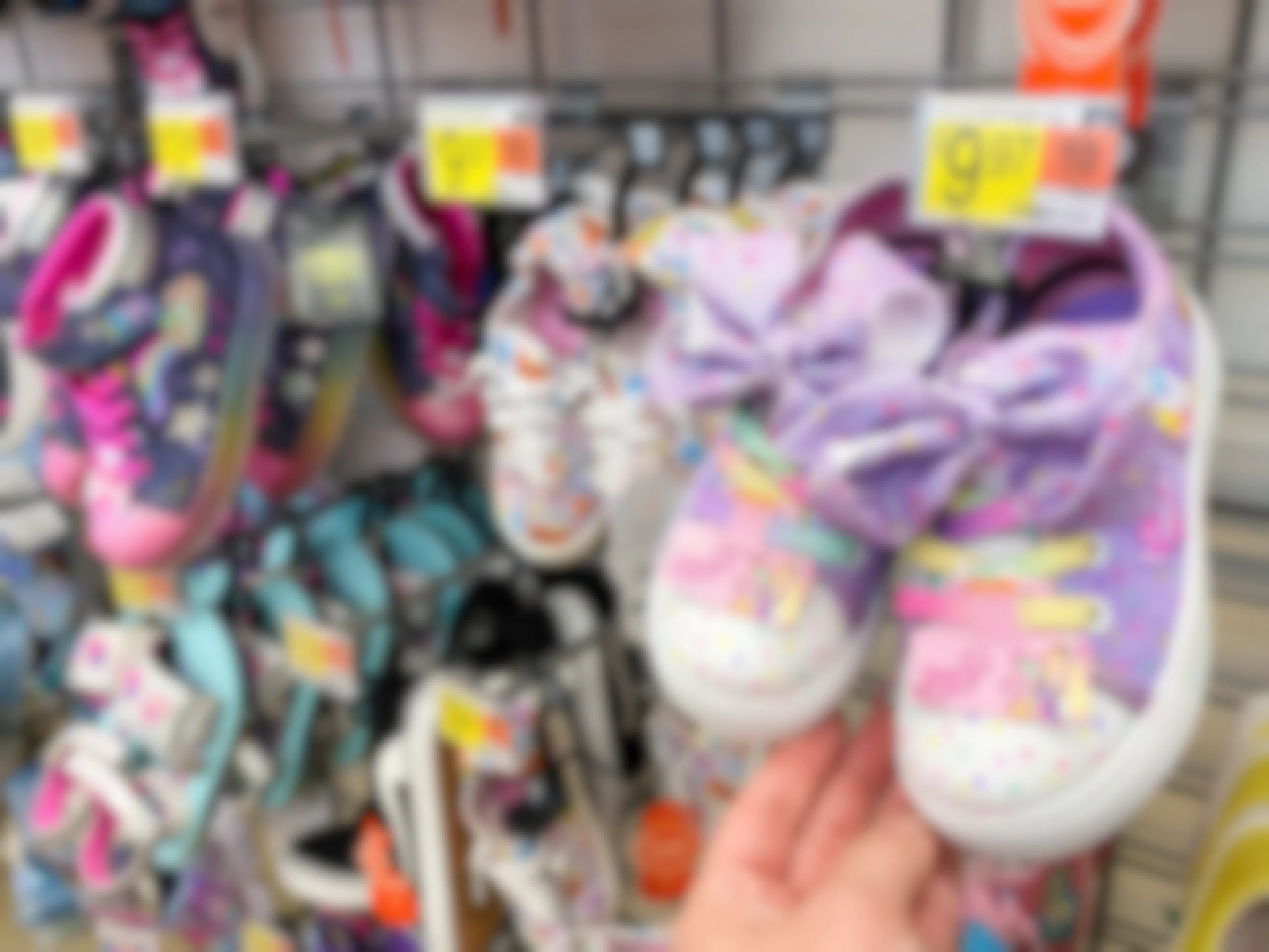 Pairs of kids shoes with sales tags showing $9.97 at Walmart