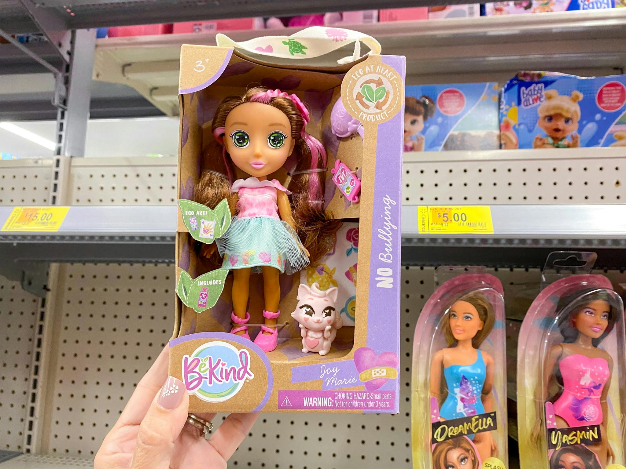 hand holding be kind doll at walmart