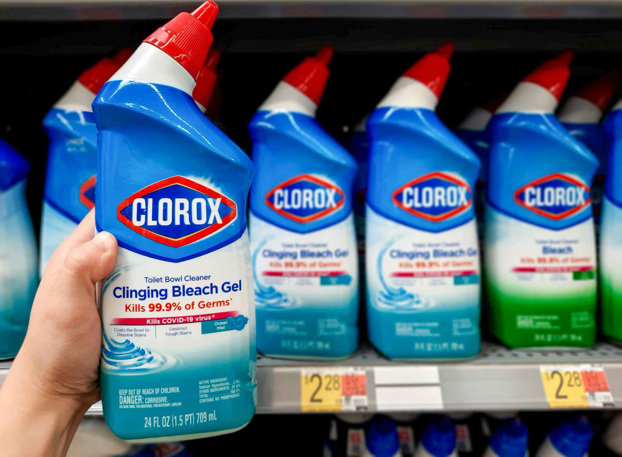 Clorox Clinging Bleach Gel Toilet Bowl Cleaner held in front of shelf at Walmart