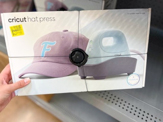 hand holding cricut hat press on clearance shelf at walmart