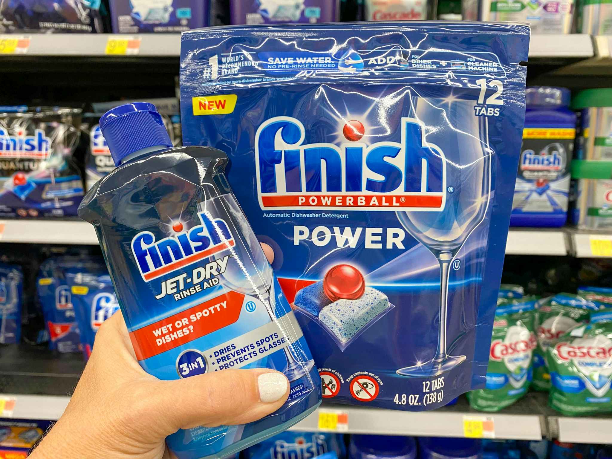 Finish Powerball Tabs and Finish Jet Dry products held in cleaning aisle at Walmart
