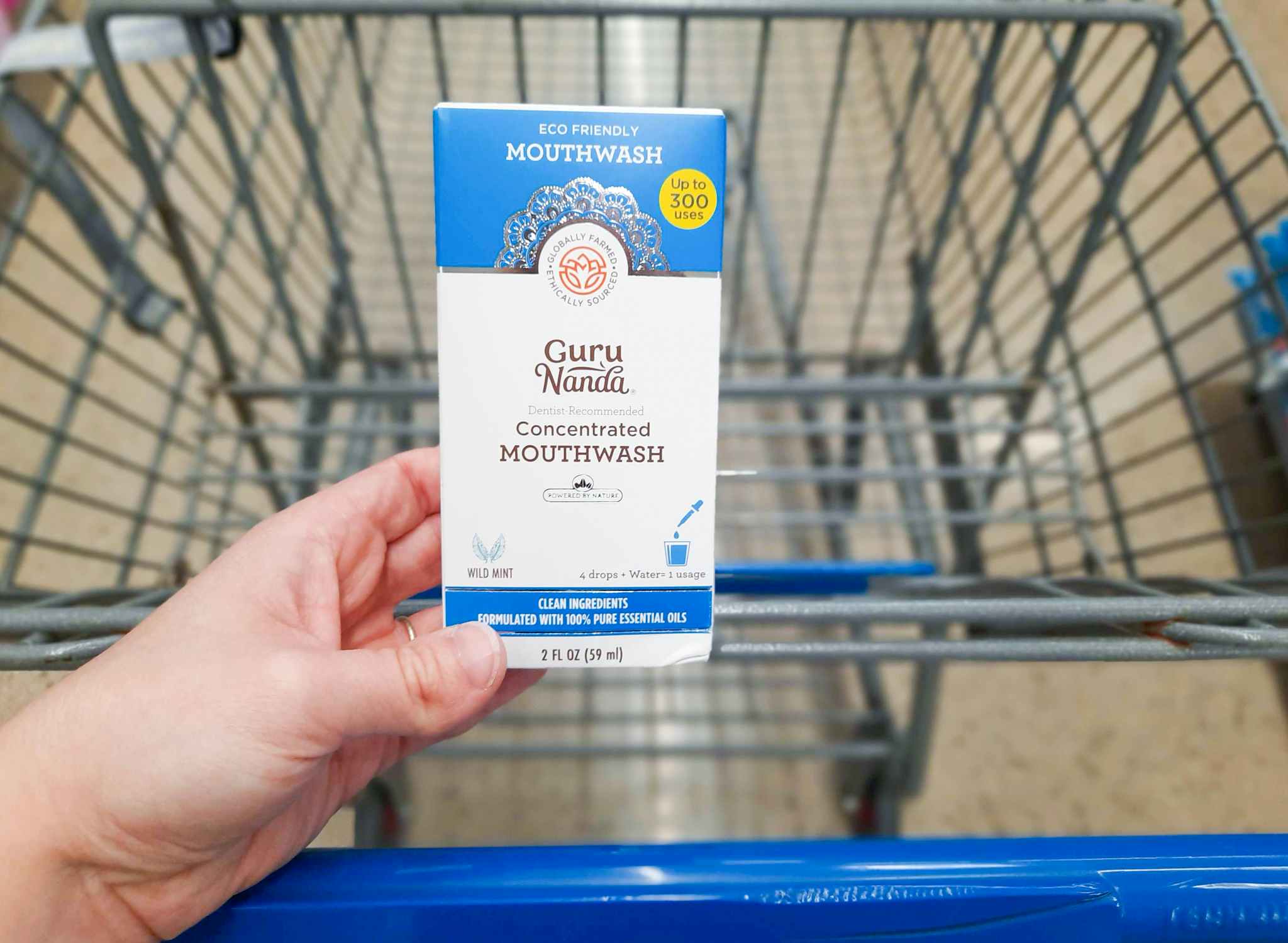 GuruNanda Concentrated Mouthwash product held over Walmart shopping cart