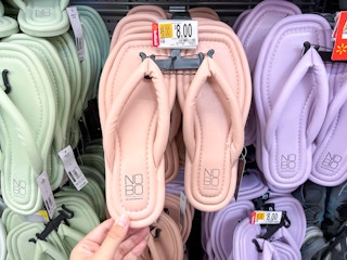 hand holding no boundaries puffy flip flops on hanger at walmart