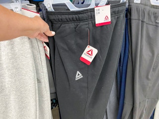 hand holding reebok mens fleece joggers at walmart