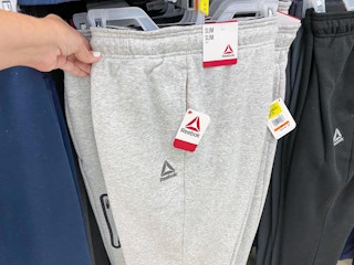 hand holding reebok mens fleece joggers at walmart