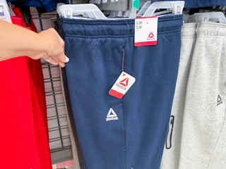 hand holding reebok mens fleece joggers at walmart