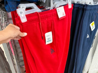 hand holding reebok mens fleece joggers at walmart