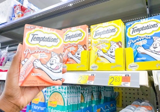 One package of Temptations Purre Cat Treats held in front of $2.63 price tag at Walmart
