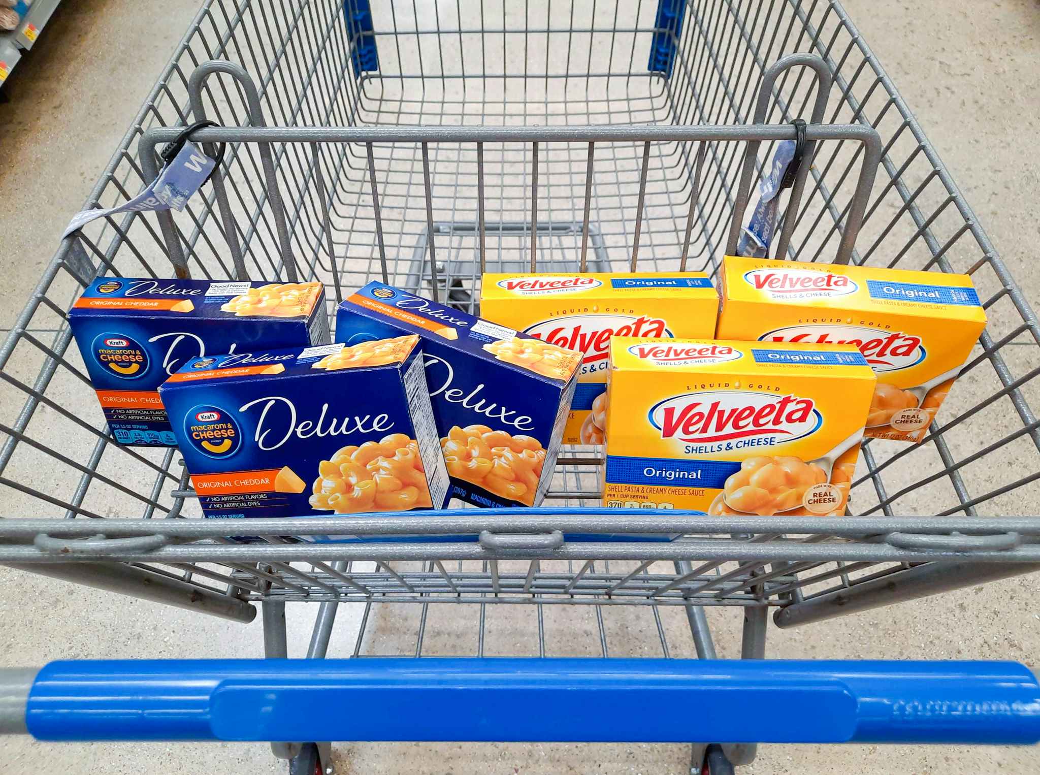 Kraft Deluxe Mac and Cheese and Velveeta Shells and Cheese in Walmart shopping cart