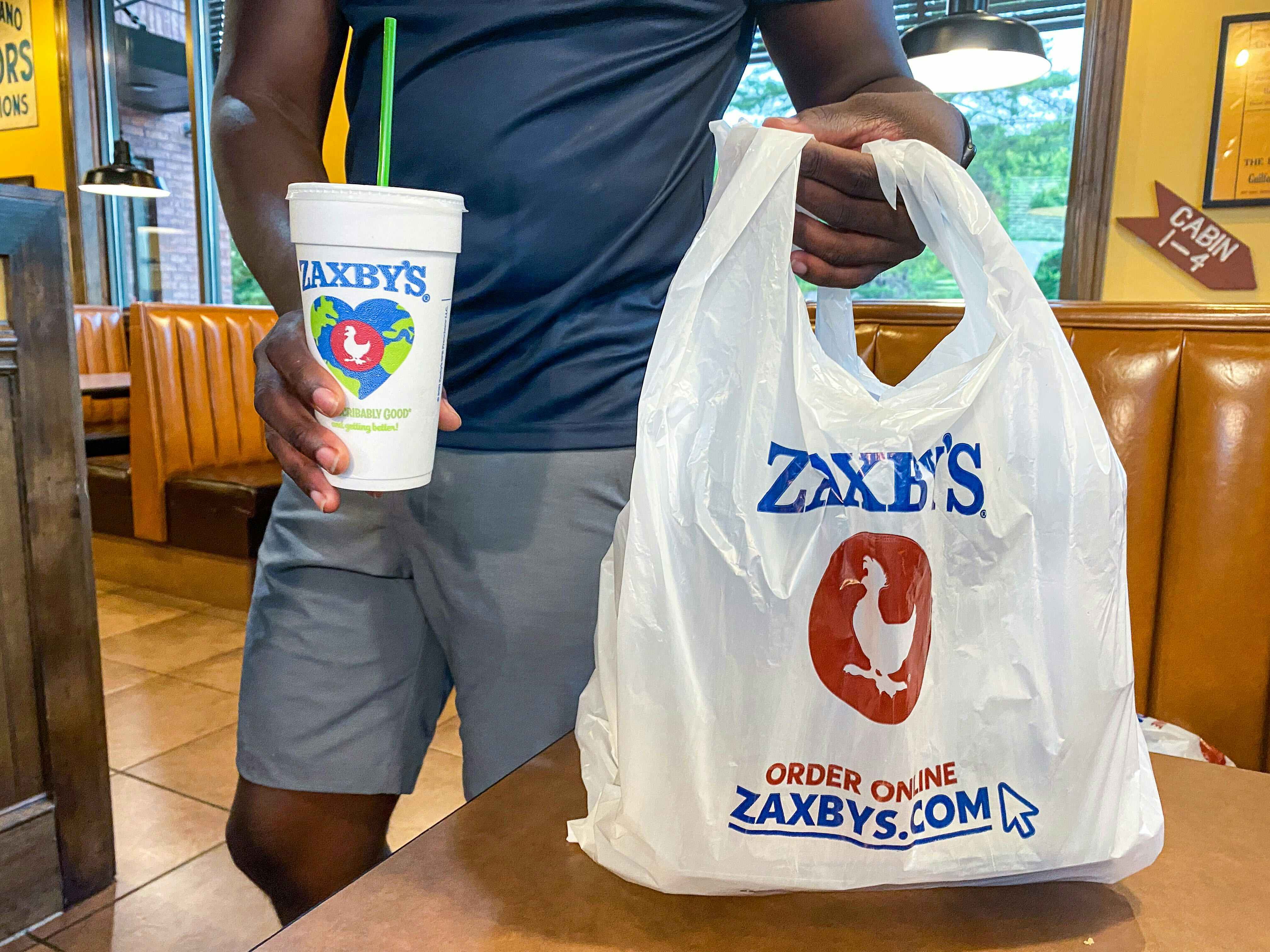 zaxby's bag and drink being held in store 