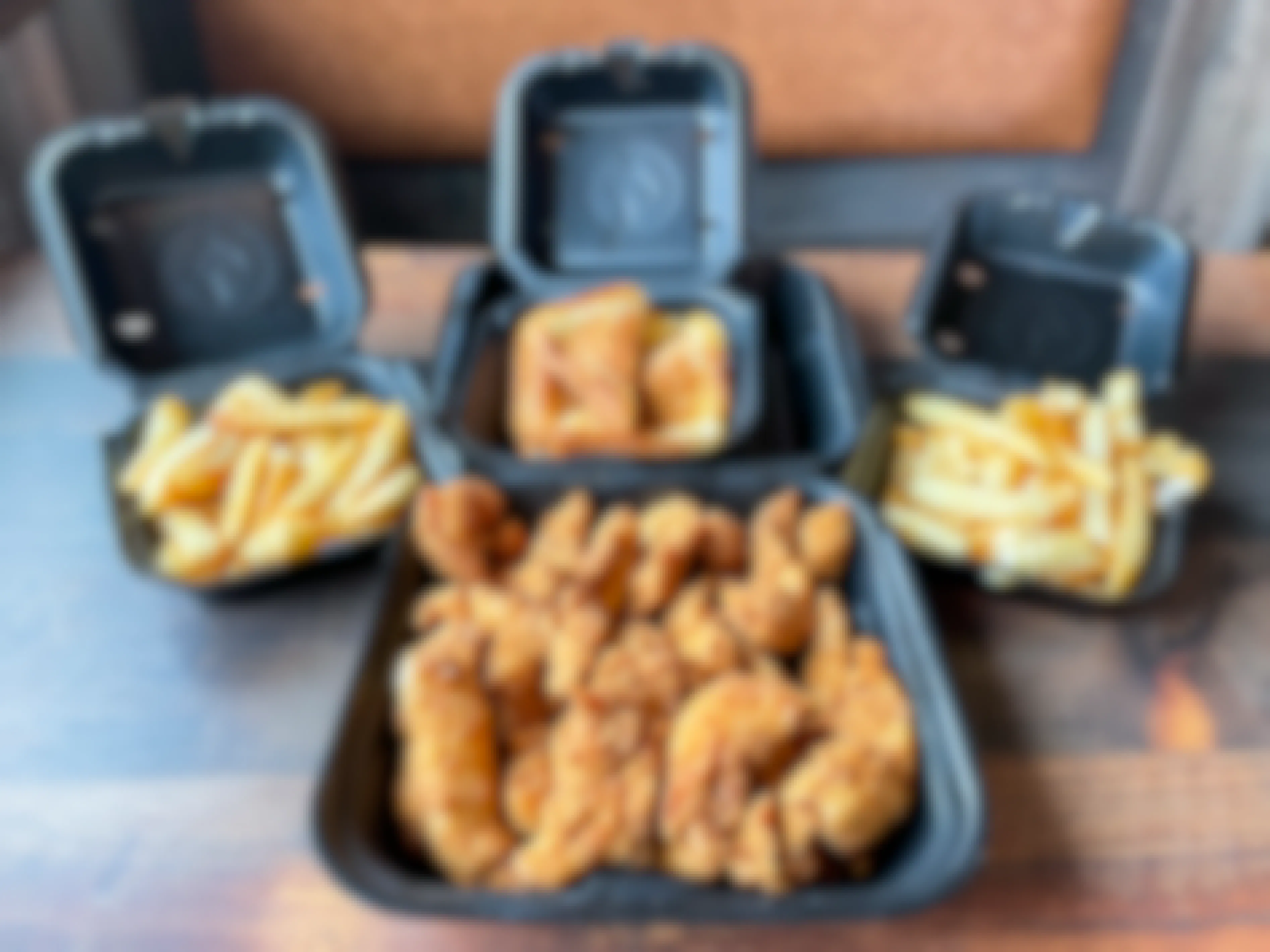 A chicken tender family meal from Zaxby's in open boxes on a table.